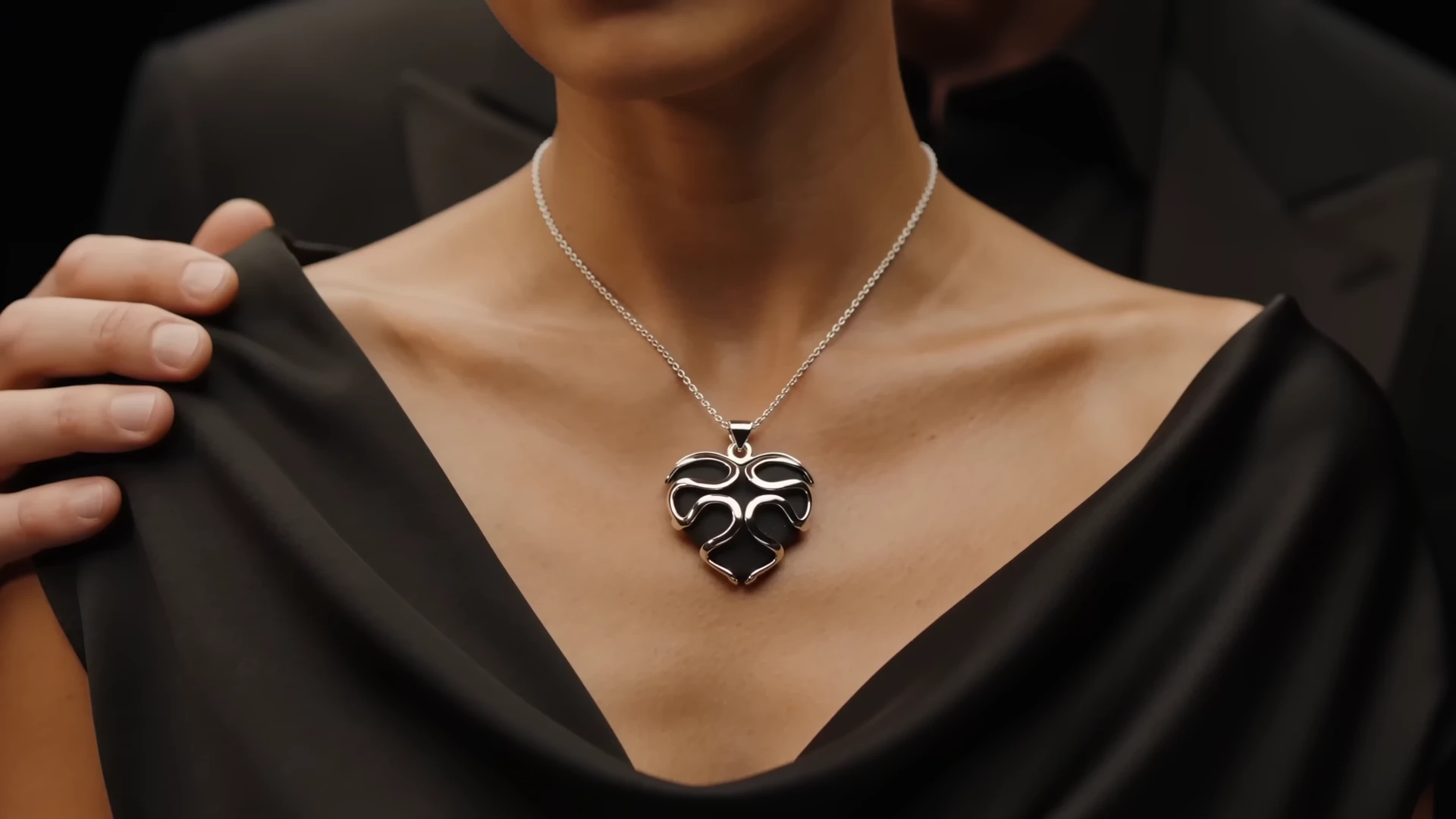 Woman wearing the KeepSayk pendant with a man standing behind her